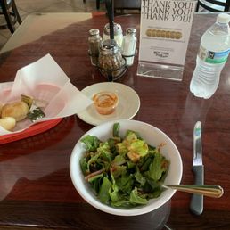 Salad with house dressing and rolls. Salad with house dressing and rolls.