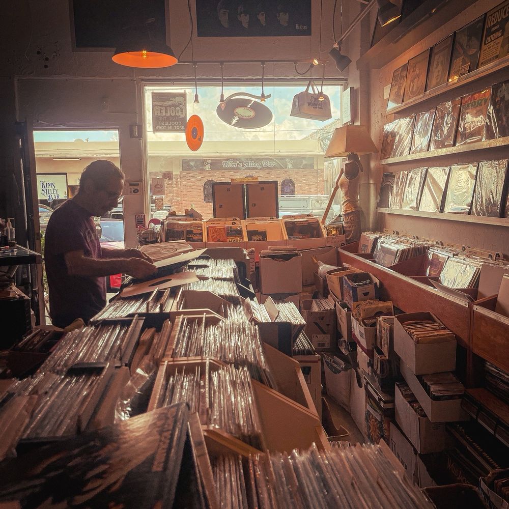 Vinyl Destination - Interior of the shop with the owner sorting through some vinyl records - Vinyl Records Near Me - Fort Lauderdale, Florida Vinyl Destination - Interior of the shop with the owner sorting through some vinyl records - Vinyl Records Near Me - Fort Lauderdale, Florida