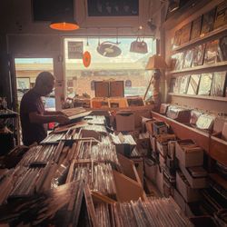 Vinyl Destination - Interior of the shop with the owner sorting through some vinyl records