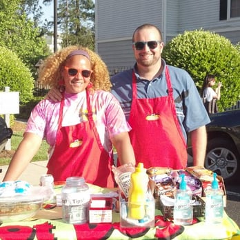 Dang Good Dogs - a man and a woman standing behind a table - Street Vendors Near Me
