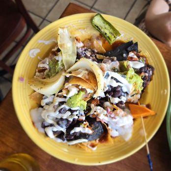 The Grain Cafe - Nacho with grilled onion, black beans, house made sour cream, guacamole, and ranchero sauce. It's really delicious! - Vegan Near Me - Long Beach, California The Grain Cafe - Nacho with grilled onion, black beans, house made sour cream, guacamole, and ranchero sauce. It's really delicious! - Vegan Near Me - Long Beach, California