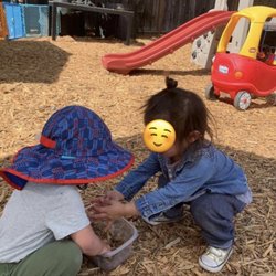 Kiddie Cottage Spanish Immersion Daycare & Preschool - Outdoor play area making "food" to share