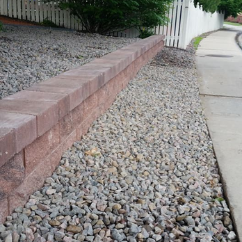 Skyline Landscape & Design - a brick retaining wall along a sidewalk - Landscaping Near Me Skyline Landscape & Design - a brick retaining wall along a sidewalk - Landscaping Near Me