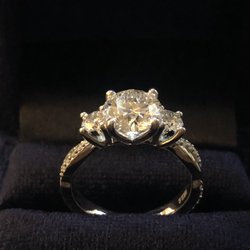 Three stone engagement ring with twisted foundation