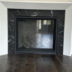 RAPHA'S TILE - Beveled Marble fire place with perfect 45 degree angle cuts that line up.