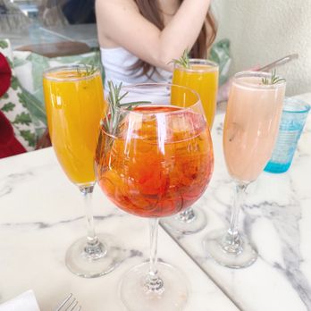 Blue Daisy - Aperol spritz in the front, mimosas in the back - Creperies Near Me - Santa Monica, California Blue Daisy - Aperol spritz in the front, mimosas in the back - Creperies Near Me - Santa Monica, California