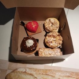 Strawberry cheesecake, a couple Paris-Brest, almond financier and a cholate dessert (forgot the name). And a baguette in the front! Strawberry cheesecake, a couple Paris-Brest, almond financier and a cholate dessert (forgot the name). And a baguette in the front!