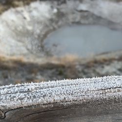 West Thumb Geyser Basin - Snowflakes on the fence vs hot spring in the background