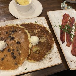 Blueberry and banana granola pancakes. Grits and million dollar bacon. Blueberry and banana granola pancakes. Grits and million dollar bacon.