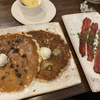 First Watch - Blueberry and banana granola pancakes. Grits and million dollar bacon. - Breakfast & Brunch Near Me - Brentwood, Tennessee First Watch - Blueberry and banana granola pancakes. Grits and million dollar bacon. - Breakfast & Brunch Near Me - Brentwood, Tennessee