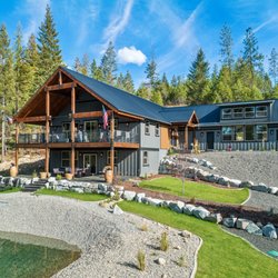 Cedar West Designs - Athol full landscape from raw land to gorgeous lawn, sprinklers, boulder edge, and summer swimming pond/winter ice skating rink.