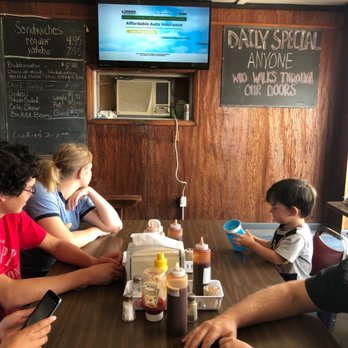 Bubba Q's - a group of people sitting at a table - Barbeque Near Me - Beloit, Kansas