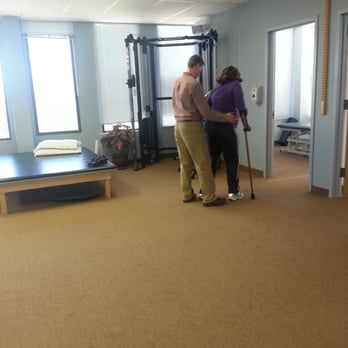 First Step Physical Therapy - Helping an amputee to walk with her prosthetic - Physical Therapy Near Me - Melville, New York First Step Physical Therapy - Helping an amputee to walk with her prosthetic - Physical Therapy Near Me - Melville, New York