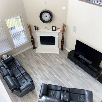 GC Flooring Pros - a living room with black leather furniture - Flooring Near Me - Frisco, Texas GC Flooring Pros - a living room with black leather furniture - Flooring Near Me - Frisco, Texas