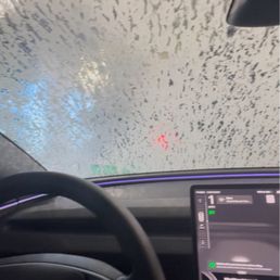Inside view of vehicle going through the Quick Quack Car Wash tunnel during the wash cycle Inside view of vehicle going through the Quick Quack Car Wash tunnel during the wash cycle