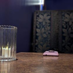 The Meridian - Booth inside of speakeasy with candle-light ambiance