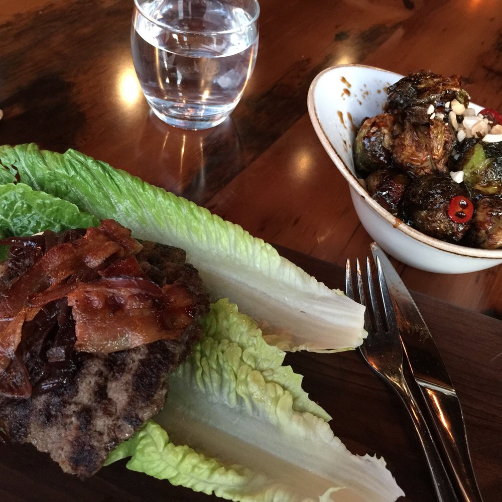 Bison and boar burger on romaine with Kung pao Brussels sprouts Bison and boar burger on romaine with Kung pao Brussels sprouts