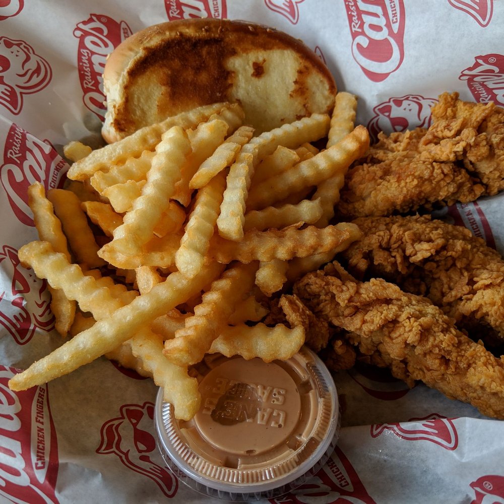 Raising Cane's Chicken Fingers - Three-piece chicken tenders, with Cane sauce, fries, and buttered toast - Fast Food Near Me - Plano, Texas Raising Cane's Chicken Fingers - Three-piece chicken tenders, with Cane sauce, fries, and buttered toast - Fast Food Near Me - Plano, Texas