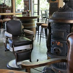 Barber chair by pot belly stove, had fire going. Nice and toasty on a cold June day b