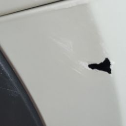 Front passenger side bumper damaged. Pulling car out of garage & got too close to the garage opening. I tried touch up paint. Front passenger side bumper damaged. Pulling car out of garage & got too close to the garage opening. I tried touch up paint.