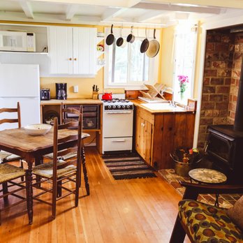 Olema Cottages - Berry Vine Cottage: Full kitchen with gas range, table for four and wood burning stove for cozy nights - Vacation Rentals Near Me - Olema, California