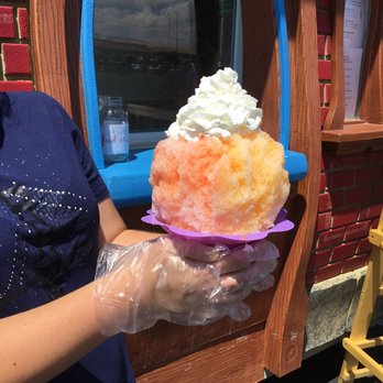 Piggy’s Shaved Ice - a woman holding a large ice cream cone - Ice Cream & Frozen Yogurt Near Me - Page, Arizona Piggy’s Shaved Ice - a woman holding a large ice cream cone - Ice Cream & Frozen Yogurt Near Me - Page, Arizona