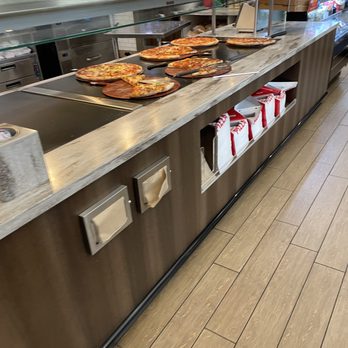 RaceTrac - a counter with pizzas on it - Gas Stations Near Me - Longwood, Florida RaceTrac - a counter with pizzas on it - Gas Stations Near Me - Longwood, Florida