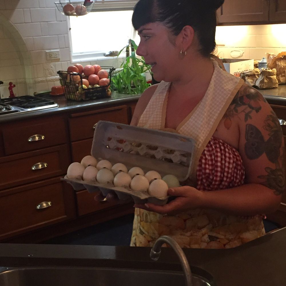 Duck eggs for the carbonara and picked veggies behind her.