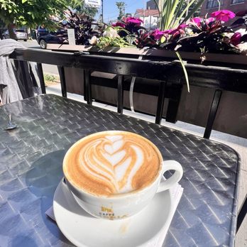 Caffe Umbria - Caffe latte with almond milk. The cup was filled to the brim, so I had to take a sip before moving to our table outside. - Coffee & Tea Near Me - Chicago, Illinois