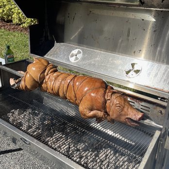 Cauble’s Cave - a pig roasting on a grill - Chicken Wings Near Me - Winter Garden, Florida