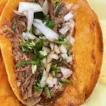 Birria De Res Estilo Tijuana - Close up of the filling in a birria taco - Tacos Near Me Birria De Res Estilo Tijuana - Close up of the filling in a birria taco - Tacos Near Me