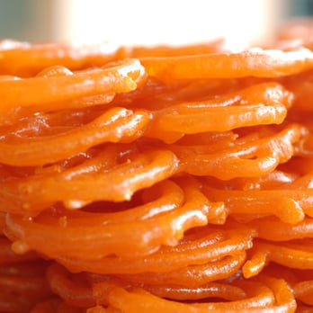 Sweet India Restaurant - a close up of a pile of sweet indian food - Indian Near Me - Mississauga, Ontario
