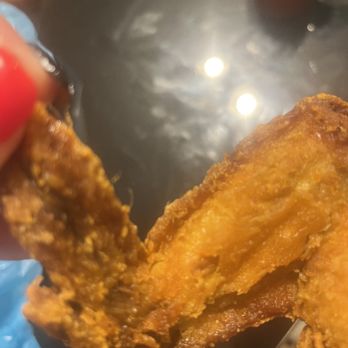 Imperial Wok - a hand holding a fried chicken - Chinese Near Me - Akron, Ohio