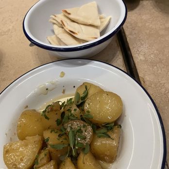 Souvla - Juicy potatoes, and a side of pita to sop up all the drippings. - Greek Near Me - Larkspur, California Souvla - Juicy potatoes, and a side of pita to sop up all the drippings. - Greek Near Me - Larkspur, California