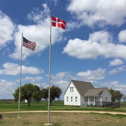 Danish Heritage Museum - The American and Danish flags flying over Danevang and the Pioneer House