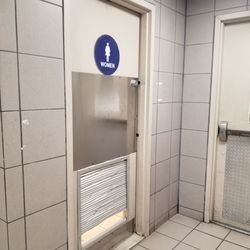 Emerald Square - Looks like someone tried to kick their way into the ladies room