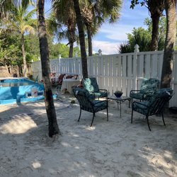 Florida Houseboat Vacations - Private beach area for guests. Includes a kayak paddleboard launch, fire pit, BBQ area, unique pontoon boat swimming pool & evening lighting