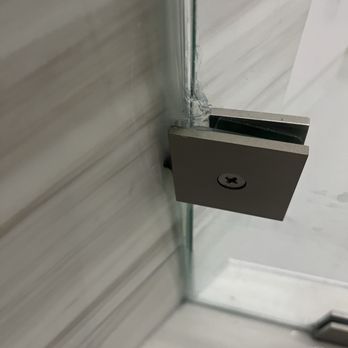 Unique Glass Design - 90 degree bracket used for angled connection. Door hinges are located on this panel and it wobbles unbelievably! - Glass & Mirrors Near Me