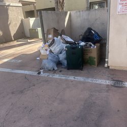 Classic Property Management - Community Trash Site. Comprising of 10 days of no trash pick up. No trash bin for residents to discard their waste.