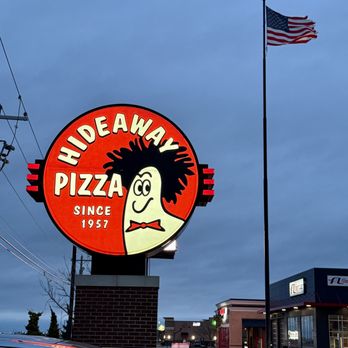 Hideaway Pizza - Outdoor sign with the American Flag in the background. - Pizza Near Me - Oklahoma City, Oklahoma Hideaway Pizza - Outdoor sign with the American Flag in the background. - Pizza Near Me - Oklahoma City, Oklahoma