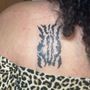 Photo of Hand and Eye Tattoo