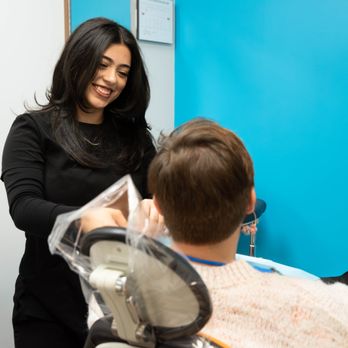 Harwood Smiles | Dentist Euless - Assistant preparing patient for visit at Harwood Smiles - General Dentistry Near Me - Euless, Texas Harwood Smiles | Dentist Euless - Assistant preparing patient for visit at Harwood Smiles - General Dentistry Near Me - Euless, Texas