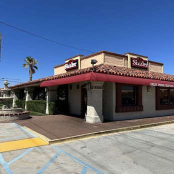 Sizzler - the outside of a restaurant with a red awning - Seafood Near Me - Palmdale, California