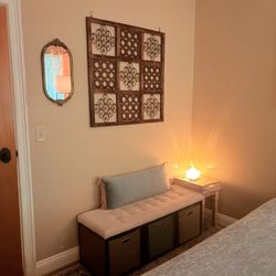 Drift Day Spa - A warm, inviting space where comfort meets tranquility. Our client seating area features a plush bench with soft, calming blue accents.