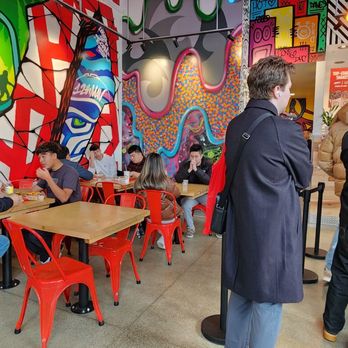 Dave's Hot Chicken - a group of people sitting at tables - Chicken Shop Near Me - Seattle, Washington