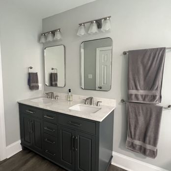 Finishing Touches Construction - a bathroom with two sinks and mirrors - General Contractors Near Me - Charlotte, North Carolina