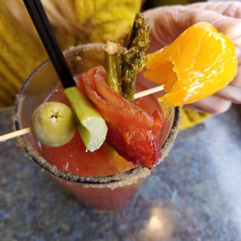 Newton's Paradise Cafe - a person holding a bloody drink - New American Near Me - Waterloo, Iowa