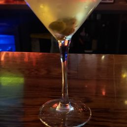 a martini with olives in it a martini with olives in it