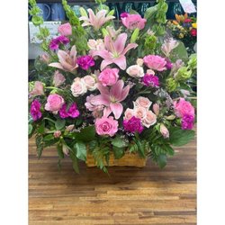 Pink lily and rose basket arrangement with greenery, representing Floral Concepts florist in Tomball.