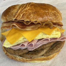 Wow !good Breakfast Sausage ham bacon egg and cheese on croissant at Tasty's donuts! Wow !good Breakfast Sausage ham bacon egg and cheese on croissant at Tasty's donuts!